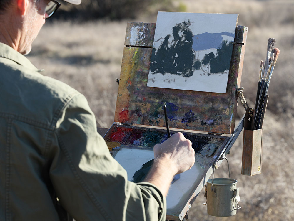 Dan Schultz working on a landscape and problem solving while painting outdoors